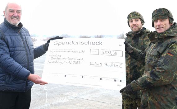 Oberstleutnant Josef Ganslmaier (re.) und Leutnant Norman Seedorf (m.) übergeben den symbolischen Spendenscheck an BwSW-Regionalstellenleiter Herbert Seubert. 